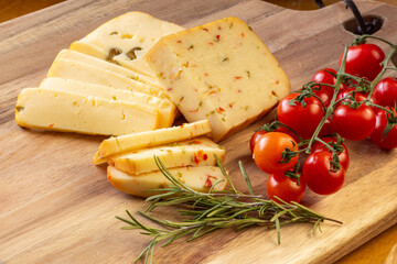 Soft cheese with olives and cheese with chili peppers with tomatoes and rosemary – wood