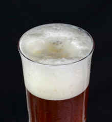 Irish red ale isolated on a black background.