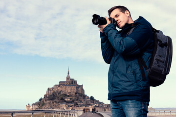 Man taking photos near Mont Saint Michel