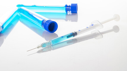 Vaccine vial. Medical syringe with needle for protection flu virus and coronavirus. Covid inoculation on white. Close up vaccine vial dose flu shot drug needle syringe.