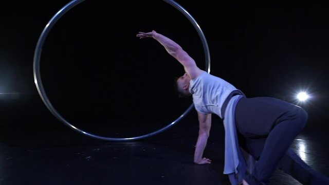 Circus artist dancing with cyr wheel. concept of concentration, willpower, and movement 
