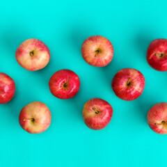Fruit pattern of red apple over blue background. Flat lay, top view. Pop art design, creative summer concept. Food background.