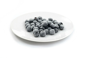 Organic frozen aronia berries on white background