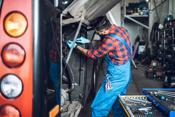 Professional bus mechanic working in vehicle repair service.