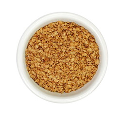 Buckwheat flakes in a bowl isolated on white background. Healthy buckwheat flakes. Healthy food.