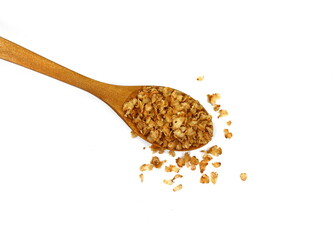 Buckwheat flakes in a wooden spoon isolated on white background. Healthy buckwheat flakes. Healthy food.