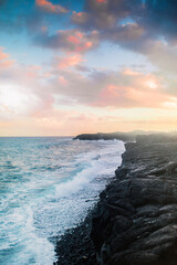 Hawaiian shore, waves and sunset over the lava beach