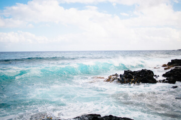 Hawaiian shore, waves and sunset over the lava beach