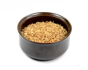 Buckwheat flakes in a bowl isolated on white background. Healthy buckwheat flakes. Healthy food.