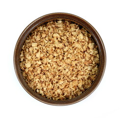 Buckwheat flakes in a bowl isolated on white background. Healthy buckwheat flakes. Healthy food.