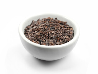 Cocoa nibs, a pieces of broken cocoa beans isolated on white background.