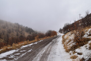 Obraz premium Snowy Hiking Trail views towards Lake Mountains Peak via Israel Canyon road towards Radio Towers in winter, Utah Lake, Wasatch Front Rocky Mountains, Provo, United States.