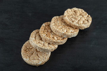 Pile of crispy rice cakes on black background