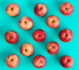 Fruit pattern of red apple over blue background. Flat lay, top view. Pop art design, creative summer concept. Food background. .