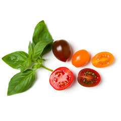 various colorful tomatoes and basil leaves isolated over white background. Top view, flat lay. Creative layout..