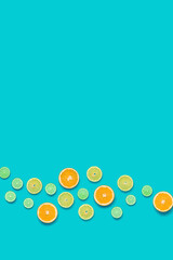 Creative layout made of colorful tropical fruits isolated on blue background. Minimal summer concept. Citrus fruit  pattern.  Pop art, flat lay, top view. Orange, Lime, Lemon slices background. 
