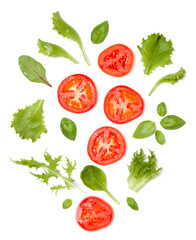 Creative layout made of tomato slices and lettuce salad leaves. Flat lay, top view. Food concept. Vegetables isolated on white background. Food ingredients pattern.
