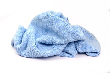 Blue micro fiber towel isolated on white background. Clean, new blue microfiber cloth isolated on white background