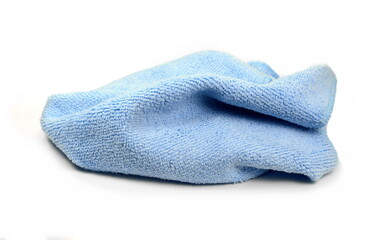 Blue micro fiber towel isolated on white background. Clean, new blue microfiber cloth isolated on white background