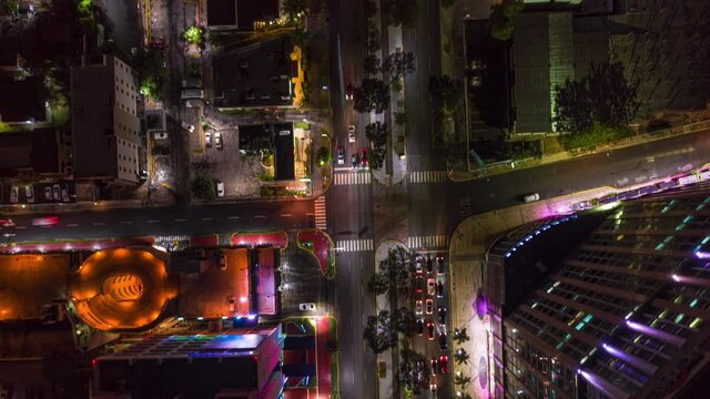 aerial time lapse hyperlapse of night traffic road in big metropolis with skyscraper urban cityscape. drone top down view of santo domingo illuminated