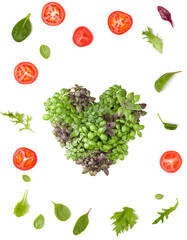 Creative layout made of tomato slices and lettuce salad leaves. Varieties of basil arrangement in form of heart. Flat lay, top view. Food concept. Vegetables isolated on white background.