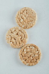 Delicious round crispbread on light gray background