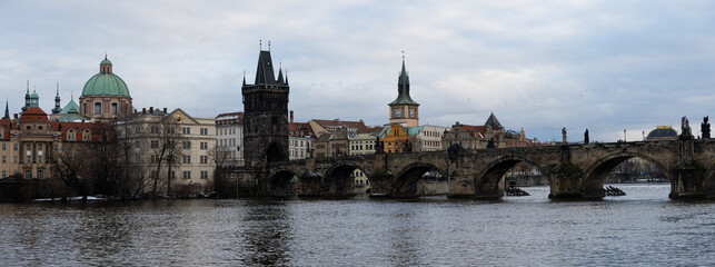 Fototapeta na wymiar .panoramic view of Charles Bridge in winter on Vltava river in Prague