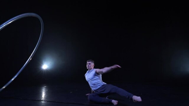 Circus artist dancing with cyr wheel. concept of concentration, willpower, and movement 