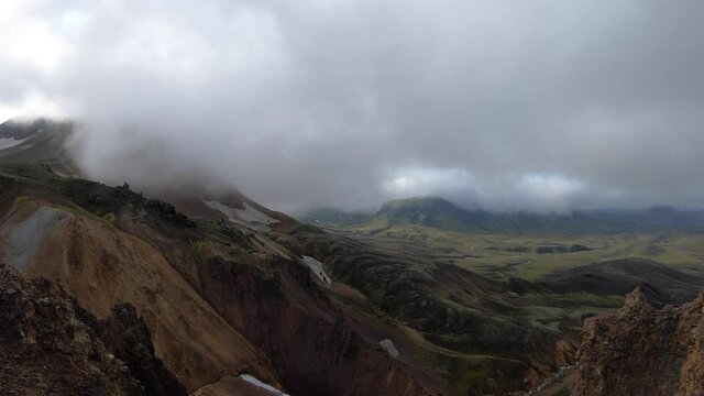 Timelapse of fog and clouds goes by mountain valley with green, foggy hills. Laugavegur hiking trail, Iceland