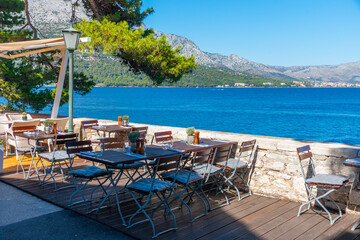 Chairs and tables at seaside promenade in the old town of Korcula, Croatia