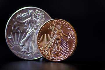 A gold and silver coin on black background