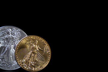 A gold and silver coin on black background