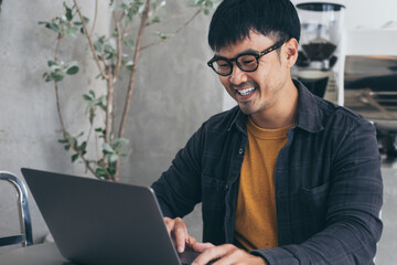 asian man work using computer hand typing laptop keyboard contact us.student study learning education online.adult professional people chatting search at office.concept for technology device business