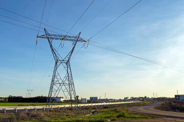 ELECTRICITY HIGH VOLTAGE TRANSMISSION TOWER. ELECTRIC NETWORK. BLUE SKY BACKGROUND. HORIZONTAL VIEW.