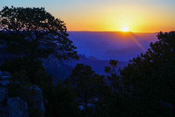Golden Sunset at Grand Canyon Arizona. Blue smoky haze accentuates the canyon.