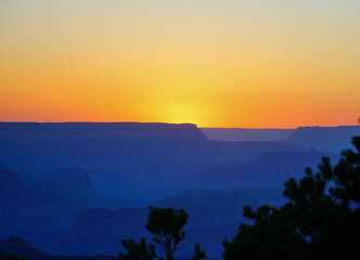 Golden Sunset at Grand Canyon Arizona. Blue smoky haze accentuates the canyon.