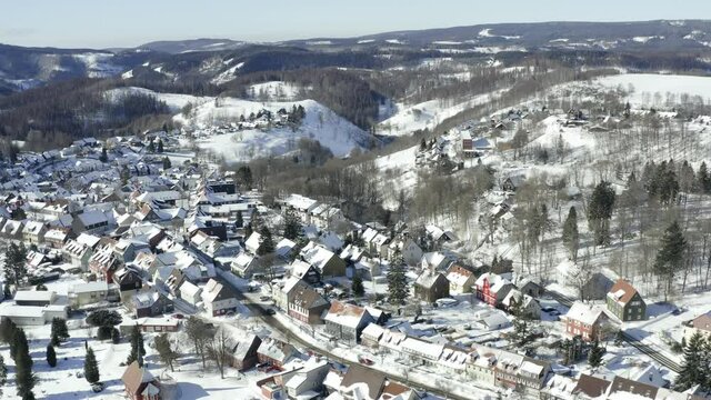 Aerial footage of the harz after a heavy snow storm in the winter of 2021. The Harz is a german national Park in with beautiful mountain landscapes in central Germany, Europe.