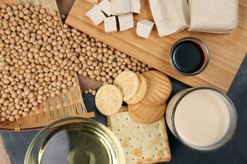 Soyabeans products soya beans flowing bamboo sieve wooden board on jute black stone slate...