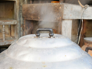 Steaming food on charcoal stove close up