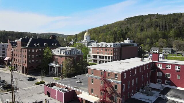 Aerial drone video of Montpelier, Vermont city flying towards state house building