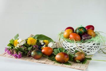 Easter eggs and spring flowers on white background