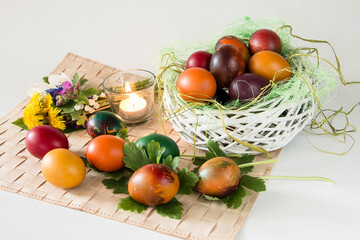 Easter eggs and spring flowers on white background