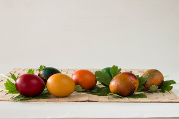 Easter eggs and spring flowers on white background