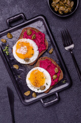 Sandwich with beetroot sauce and egg