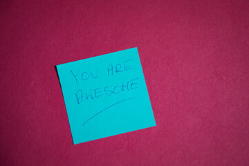 A card with handwritten text "you are awesome".