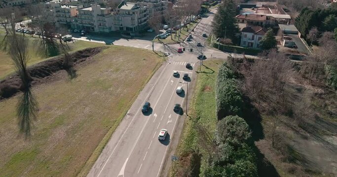 Arcore, Italy. Static Aerial View of Street Traffic in Suburban Neighborhood on Sunny Autumn Day, Drone Shot
