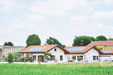 Renewable energy system on roof of traditional houses in contemporary suburban neighborhood in...