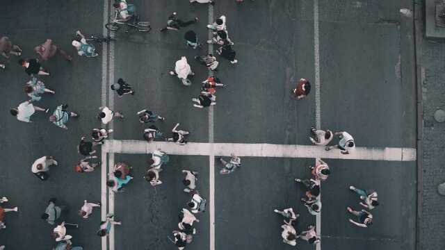 Top down pedestrians crosswalk road aerial. People cross street. Cityscape crossroad. Men, women walking at zebra. Busy town residentes lifestyle. Downtown of Kyiv city, Ukraine, Europe