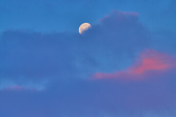Moon at sunrise behind the cloud