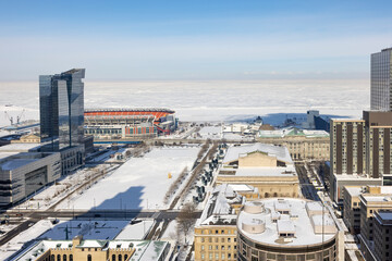 Fully frozen Lake Erie and thick snow cover with view from Cleveland downtown. 